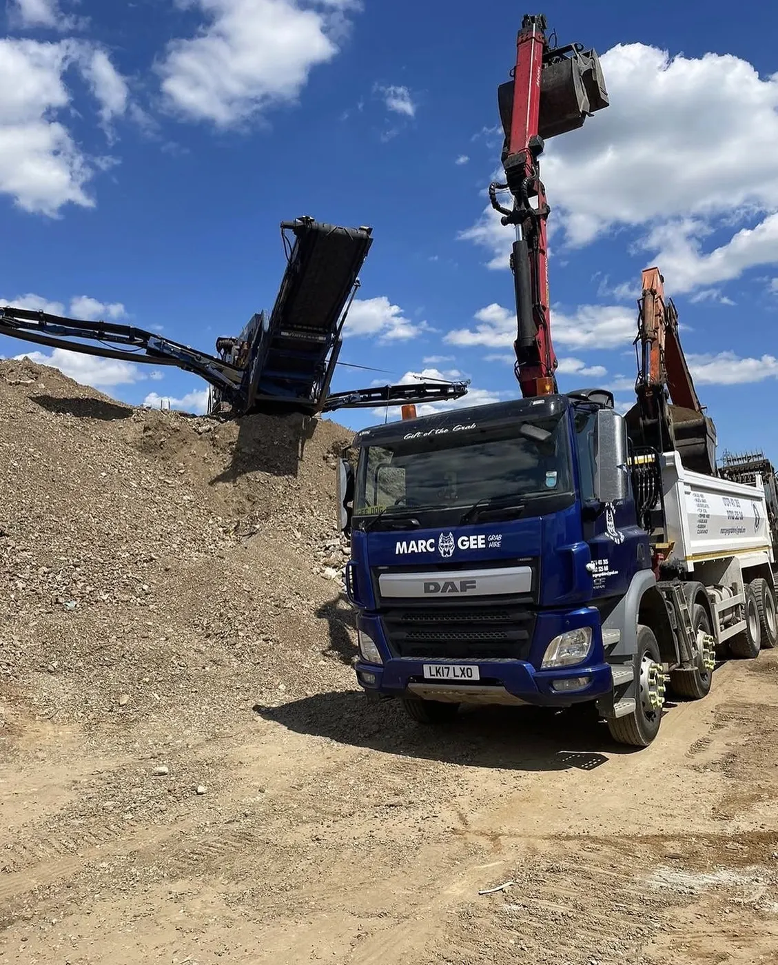 Marc Gee lorry next to a screening plant and a pile of recycled aggregate