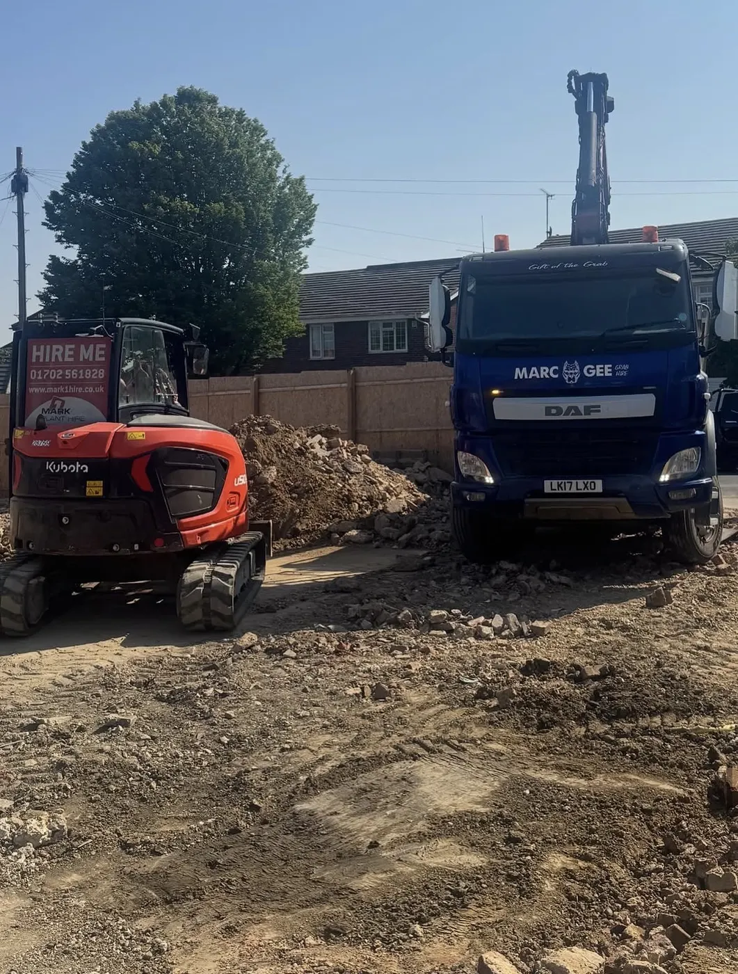 Marc Gee lorry beside a mini digger and a pile of spoil on a building site